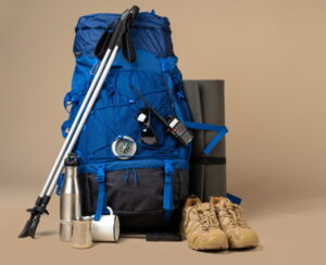 Blue backpack and hiking boots. Mountain gear ready for trip close up