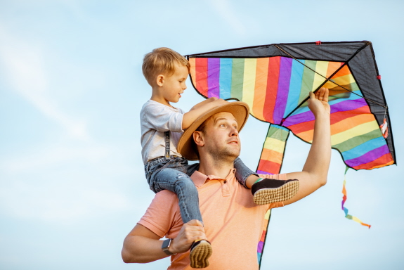 a man with his son and a kite